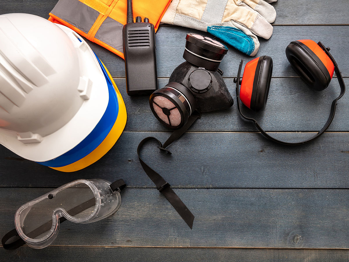 Work safety protection equipment. flat lay on wooden background.